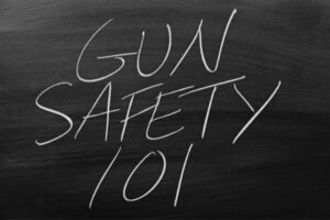 Chalkboard Writing gun Safety 101 on a Chalkboard