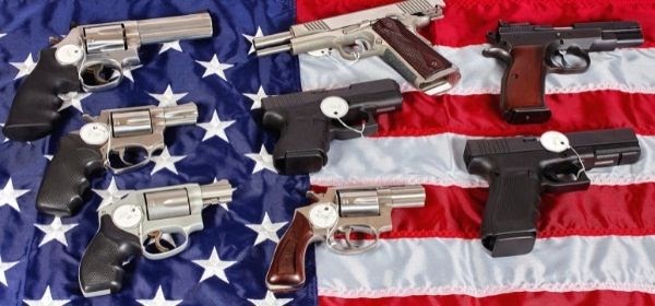 Firearms for Sale with Price Tags Placed on Top of an American Flag