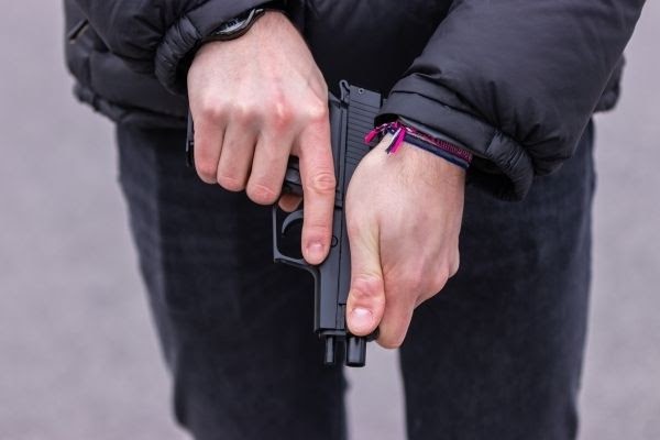 Man Examining a Firearm to Determine if It's loaded