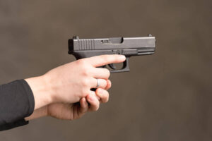 a woman gripping a compact handgun - Eastern Gun Expo a Woman Gripping a Compact Handgun