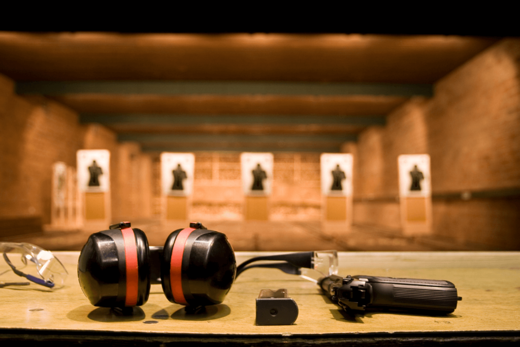 A shooting range with gun and safety items laid out