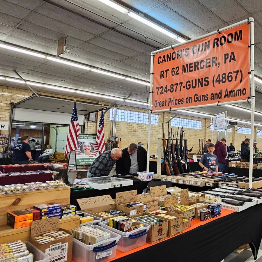Men Looking at a Vendor Table with Guns at a Pa Gun Show Hosted by Eagle Shows